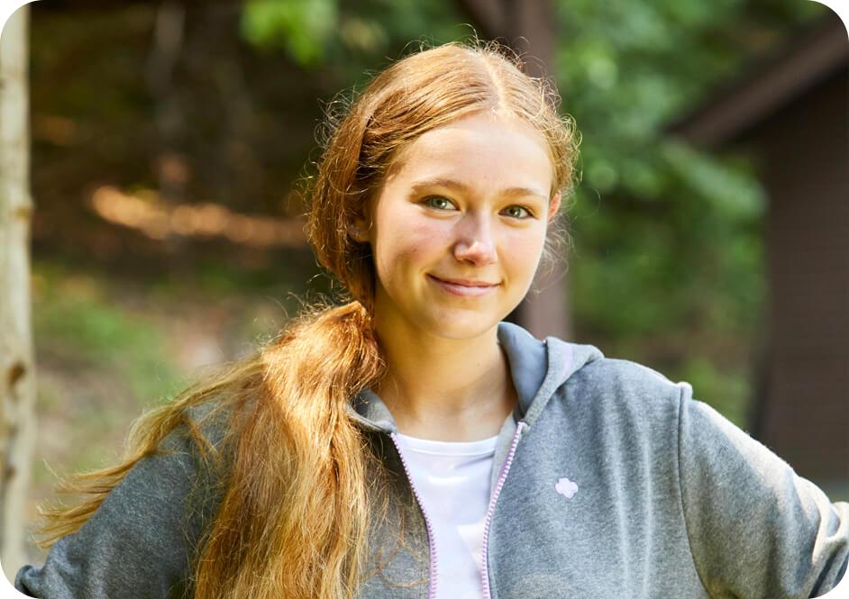 Girl wearing light grey Girl Scouts hooded sweatshirt